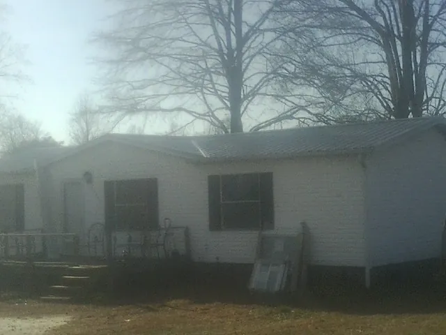 New metal roof on a white painted brick home on a foggy morning in Ramona